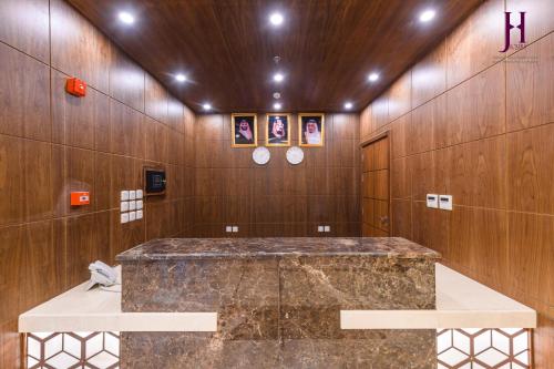 a bathroom with a marble counter in a room with wooden walls at فندق جوري الهدا مكة in Mecca