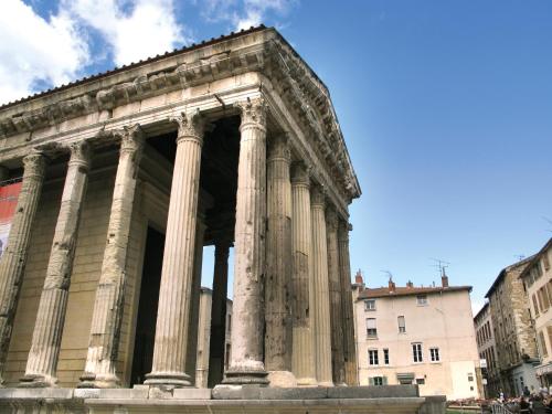 an ancient building with columns in a city at Revigora in Vienne