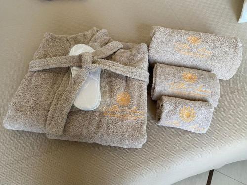a pair of towels with a spoon on top of them at Villa Anna - Suites & Events in Specchia