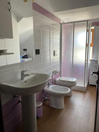 a bathroom with a sink and a toilet at Villa Anna - Suites & Events in Specchia