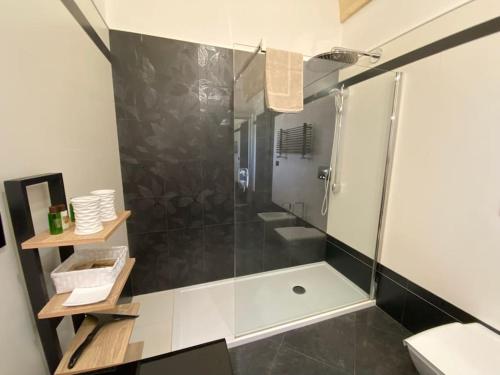 a bathroom with a shower with a glass door at Villa Anna - Suites & Events in Specchia