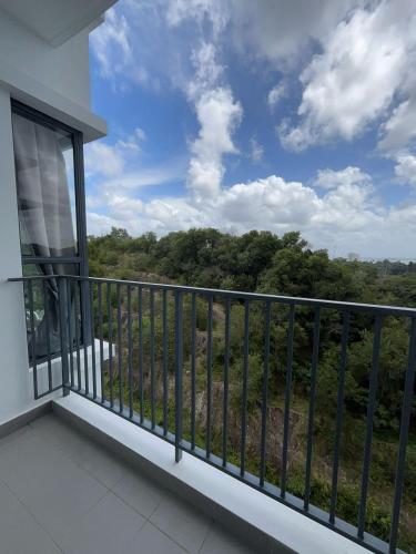 a balcony with a view of the forest at Lovely Green Forest in Sandakan