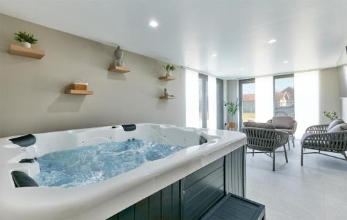 a large bath tub in a living room at 6 Bedroom Stunning Home In Podgrade 