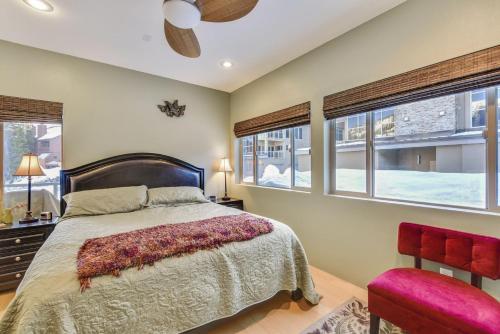 a bedroom with a bed and two windows at Slopes_loft in Brian Head
