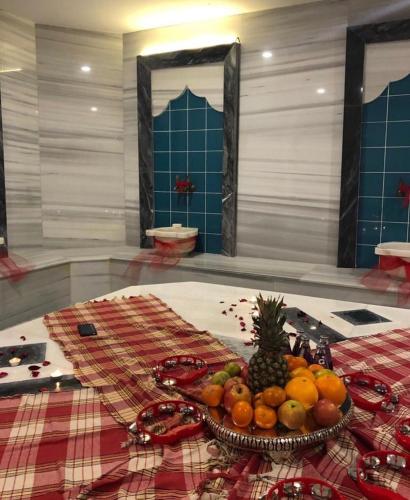 a bowl of fruit on a table in a room at MAIA Luxury Beach Hotel & Spa in Guzelcamlı