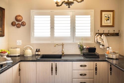 a kitchen with a sink and a window at Le Parc, Bryanston in Johannesburg