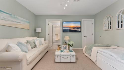 a white living room with a white couch and a bed at Residence 509 At The Grand in Wildwood