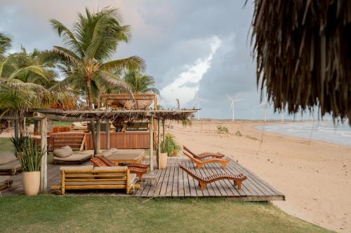 a group of chairs and tables on the beach at Villa Mango in Icaraí