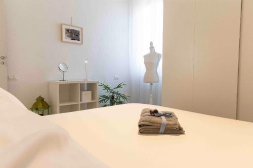a room with a bed with a towel on it at ROSSENA HOME tranquillo appartamento, con giardino, vicino al centro ed all'Ospedale Santa Maria Nuova SMN in Reggio Emilia