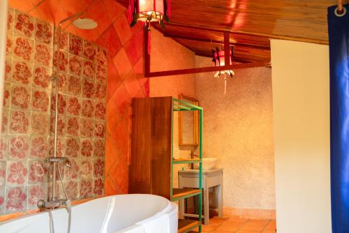 a bathroom with a bath tub in a room at Ivory Falls Villa in Di Linh