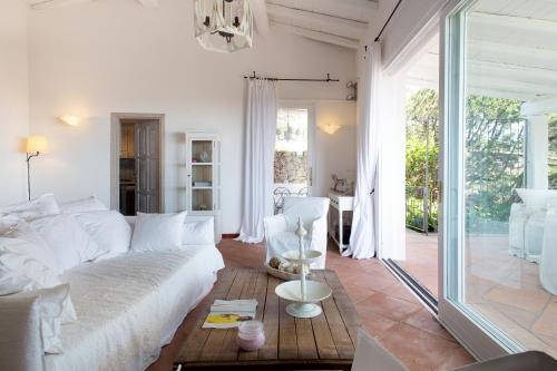a living room with a white couch and a table at Villa Florin in Porto Cervo