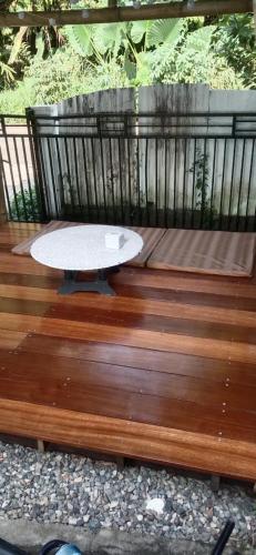a wooden deck with a table on top of it at The view padang, Amazing view, 8 mins Mentawai fast ferry, cold beer,close to restaurants in Padang
