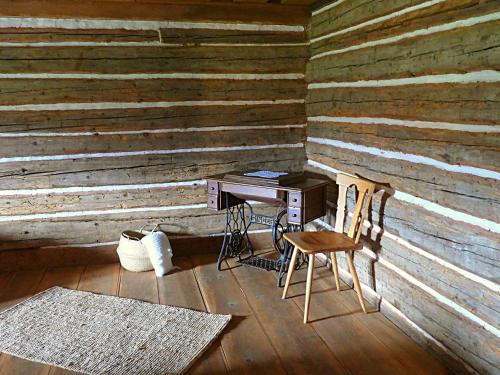 an old wooden room with a desk and a chair at Zoopark Chomutov in Chomutov