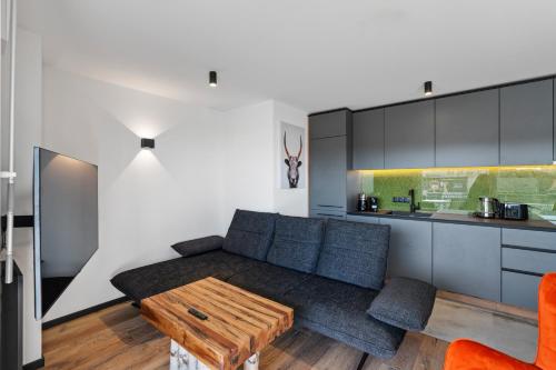 a living room with a couch and a table at Seequartier 2 - neu & hochwertig in Friedrichshafen