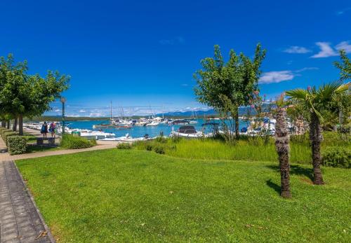 a park with a marina and boats in the water at House CAPRI with heated pool and sea view in Klimno