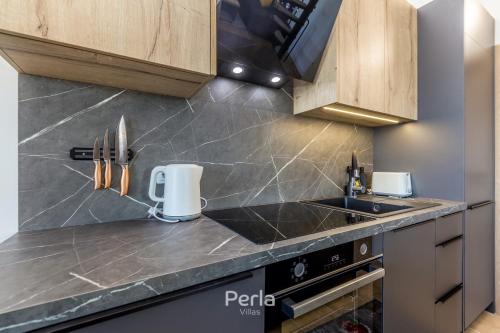a kitchen with a sink and a counter top at House CAPRI with heated pool and sea view in Klimno