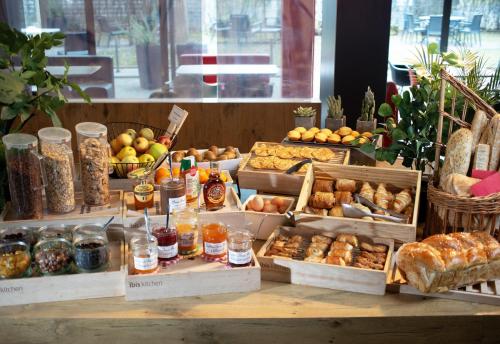 a display of different types of bread and pastries at Ibis Saint-Genis-Pouilly Genève in Saint-Genis-Pouilly
