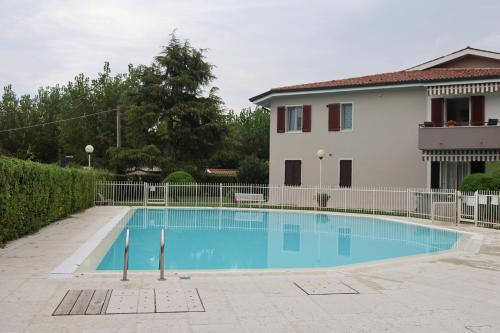 a swimming pool in front of a house at Saporedilago in Peschiera del Garda