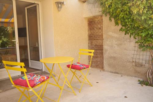 two yellow chairs and a yellow table and chairs at Revigora in Vienne