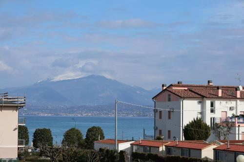 a view of a mountain from a city with buildings at Saporedilago in Peschiera del Garda