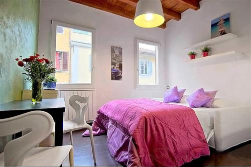 a bedroom with a bed and a desk and windows at Apartments Florence - San Gallo 3 in Florence