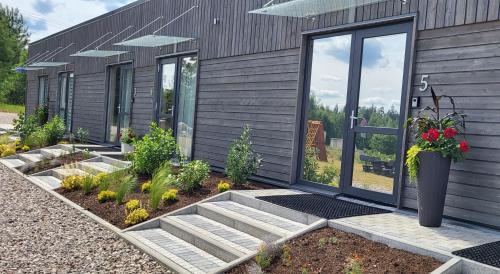 a house with a garden in front of it at Sila terases in Madona