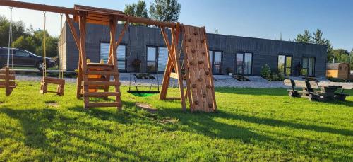 a playground with a swing set in a yard at Sila terases in Madona