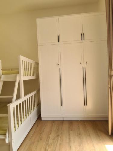 a room with white cabinets and a bunk bed at TerraCotta Beachfront Villa Phan Thiet in Phan Thiet