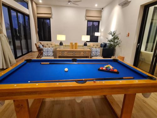 a pool table in the middle of a living room at TerraCotta Beachfront Villa Phan Thiet in Phan Thiet