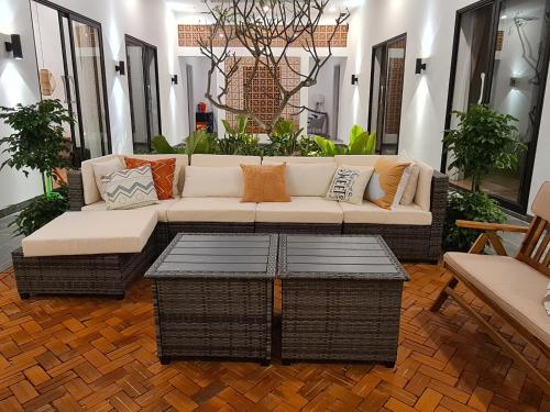 a living room with a couch and a table at TerraCotta Beachfront Villa Phan Thiet in Phan Thiet