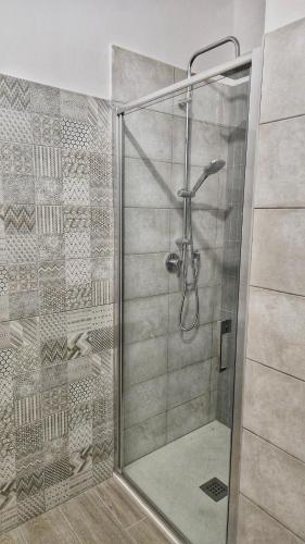 a shower with a glass door in a bathroom at Da Nella Dimora di Campagna - Maison à Porter in Vasto
