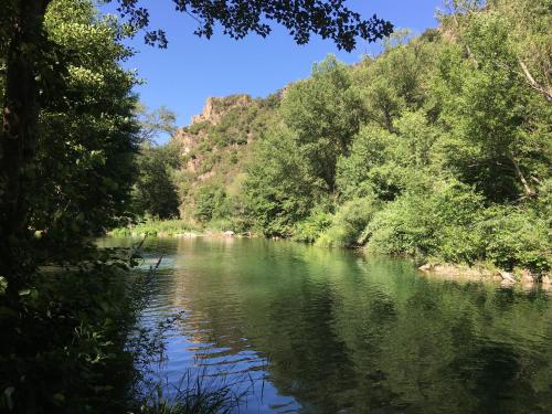 a river with trees on the side of it at Coeur de nature in Rasiguères