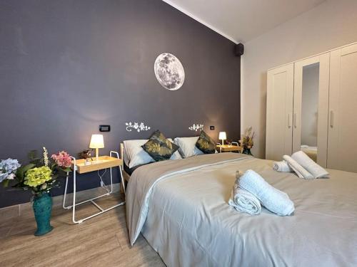 a bedroom with a large bed with two pillows on it at Marconi Suite [free parking / near the airport] in Bologna