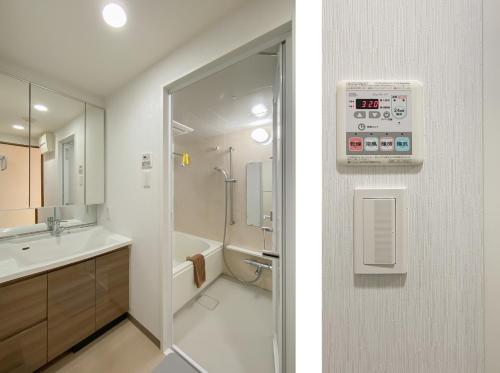 a bathroom with a shower and a sink and a toilet at 安楽途 in Tokyo