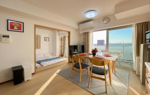 a living room with a table and a bedroom at 安楽途 in Tokyo