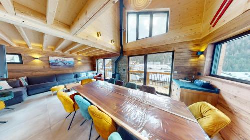 a dining room with a long table and chairs at Chalet Folie in Peisey-Nancroix