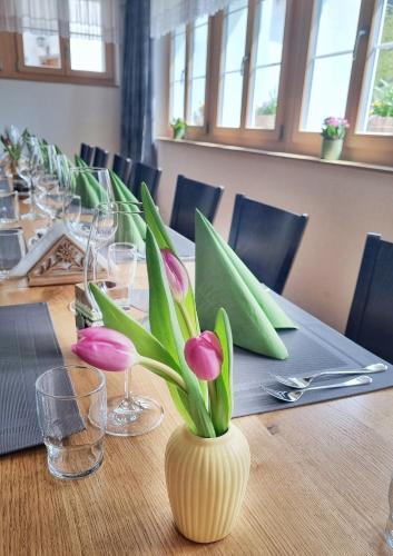 a table with a vase with flowers in it at Triftblick in Gadmen
