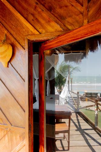 a wooden porch with a view of the beach at Villa Mango in Icaraí