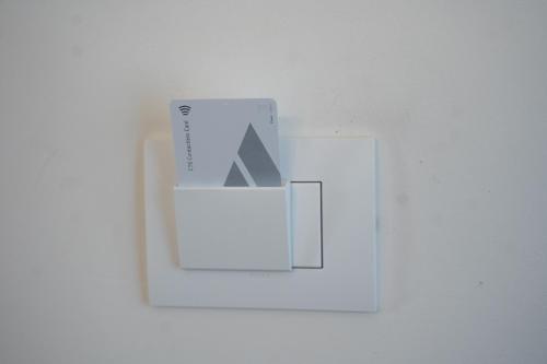 a white switch with a box on a white wall at Residenza degli Speziali in Florence