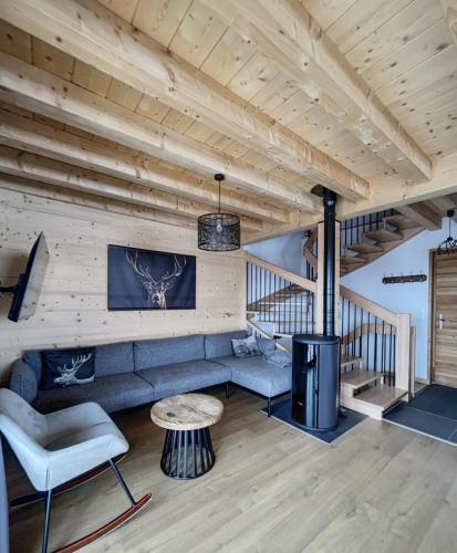 a living room with a couch and a table at Chalet Le Clapière in La Toussuire