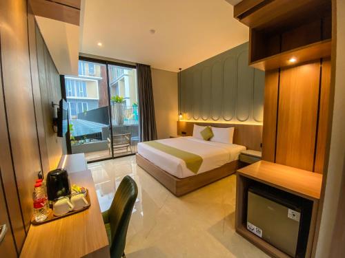 a hotel room with a bed and a television at Facade Hotel by Azana in Tawangmangu