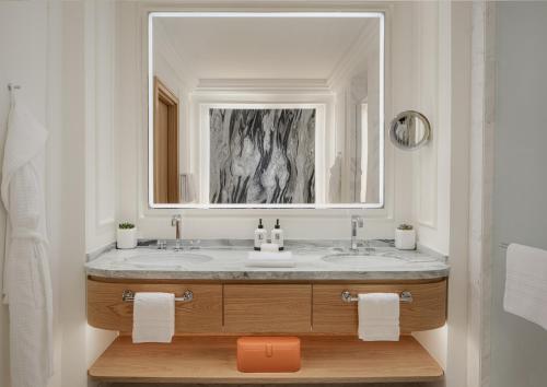 a bathroom with a sink and a mirror at Four Seasons Resort and Residences at The Pearl - Qatar in Doha