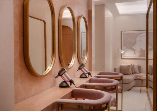 a dressing room with three mirrors on the wall at Four Seasons Resort and Residences at The Pearl - Qatar in Doha