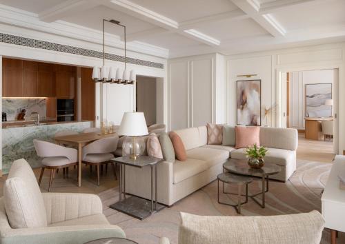 a living room with a couch and a table at Four Seasons Resort and Residences at The Pearl - Qatar in Doha