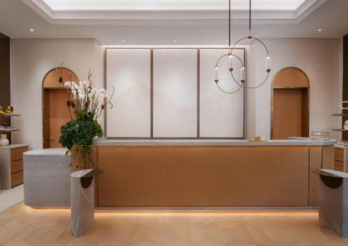a salon with a counter with a vase of flowers at Four Seasons Resort and Residences at The Pearl - Qatar in Doha