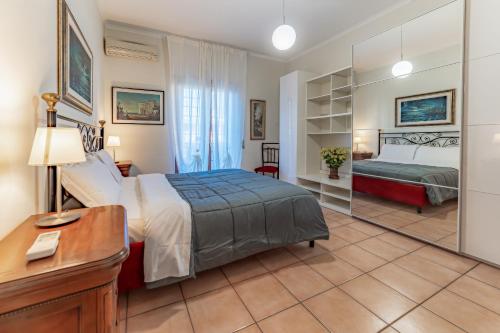 a bedroom with a bed and a desk and a mirror at Marta Suite - Metro Malatesta in Rome