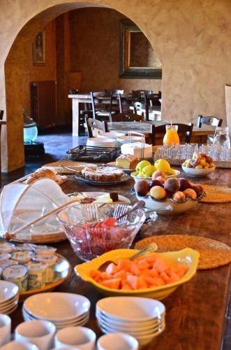 a long table with many plates and bowls of food at Azienda Agricola Mandranova in Palma di Montechiaro
