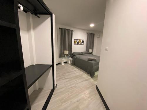a living room with a bed and a mirror at Chaweng Residence in Chaweng