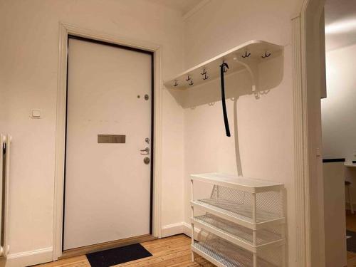 a room with a white door and an umbrella at Stay Inn Apartment Rörstrandsgatan in Stockholm