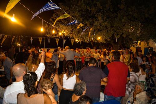 a large group of people standing in a crowd at night at Casa Del Mare Sea View House up to 6 guests in Mandrakion